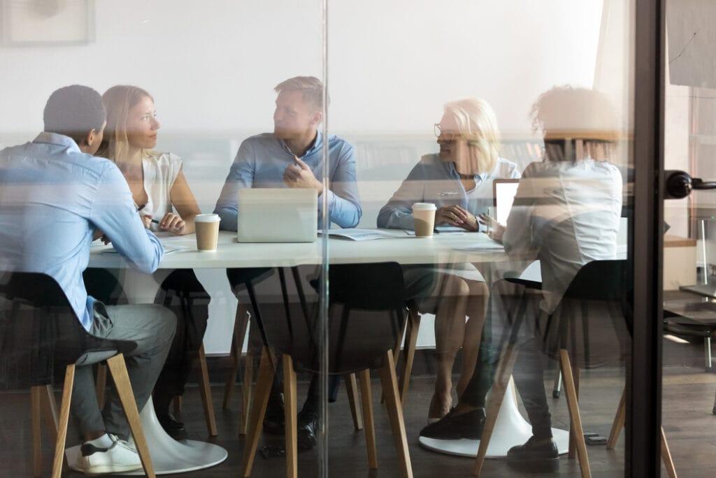 Business people negotiating at boardroom behind closed doors
