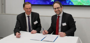 Professor Mark Spearing and Matt Goodman from OS sign the memorandum